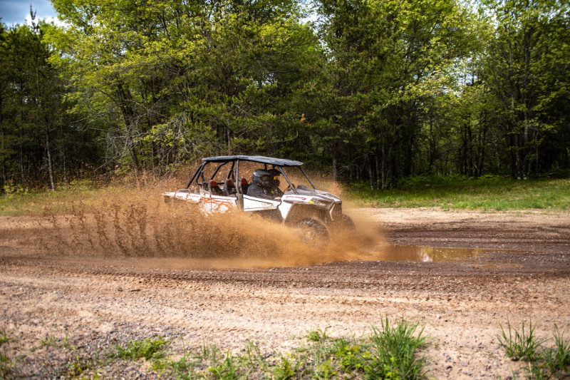 a UTV driving through mud