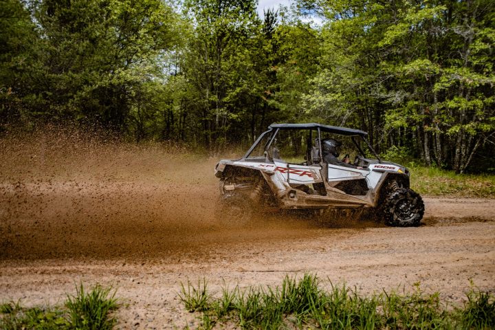 a truck driving down a dirt road