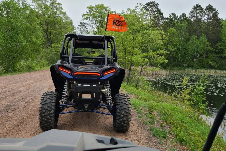 a truck driving down a dirt road