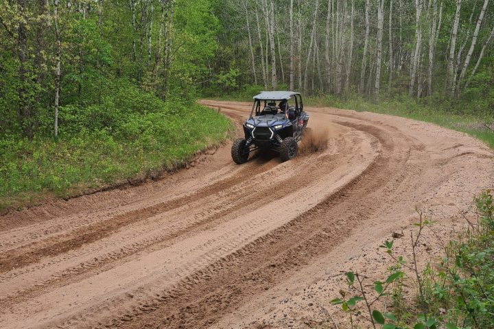 a car driving down a dirt road