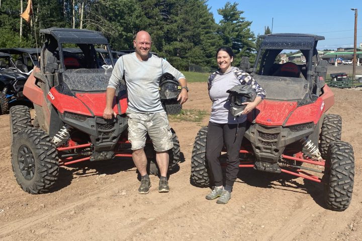 a man standing next to a tractor
