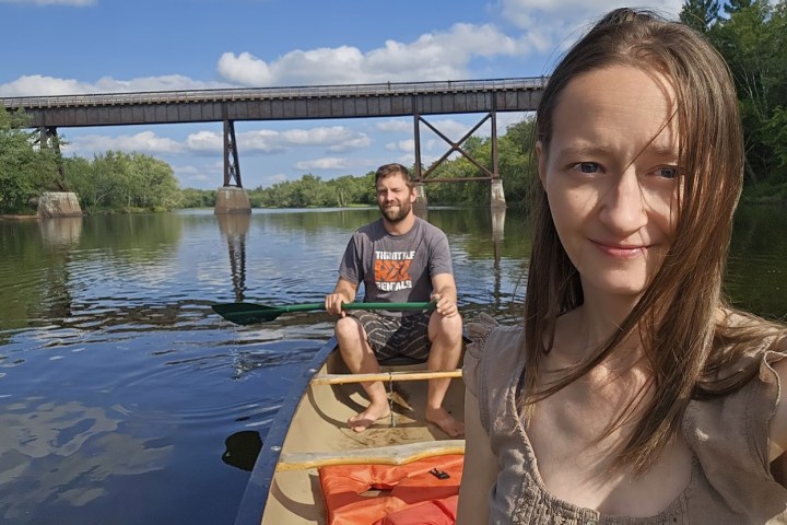 a man and woman canoeing in the st croix river