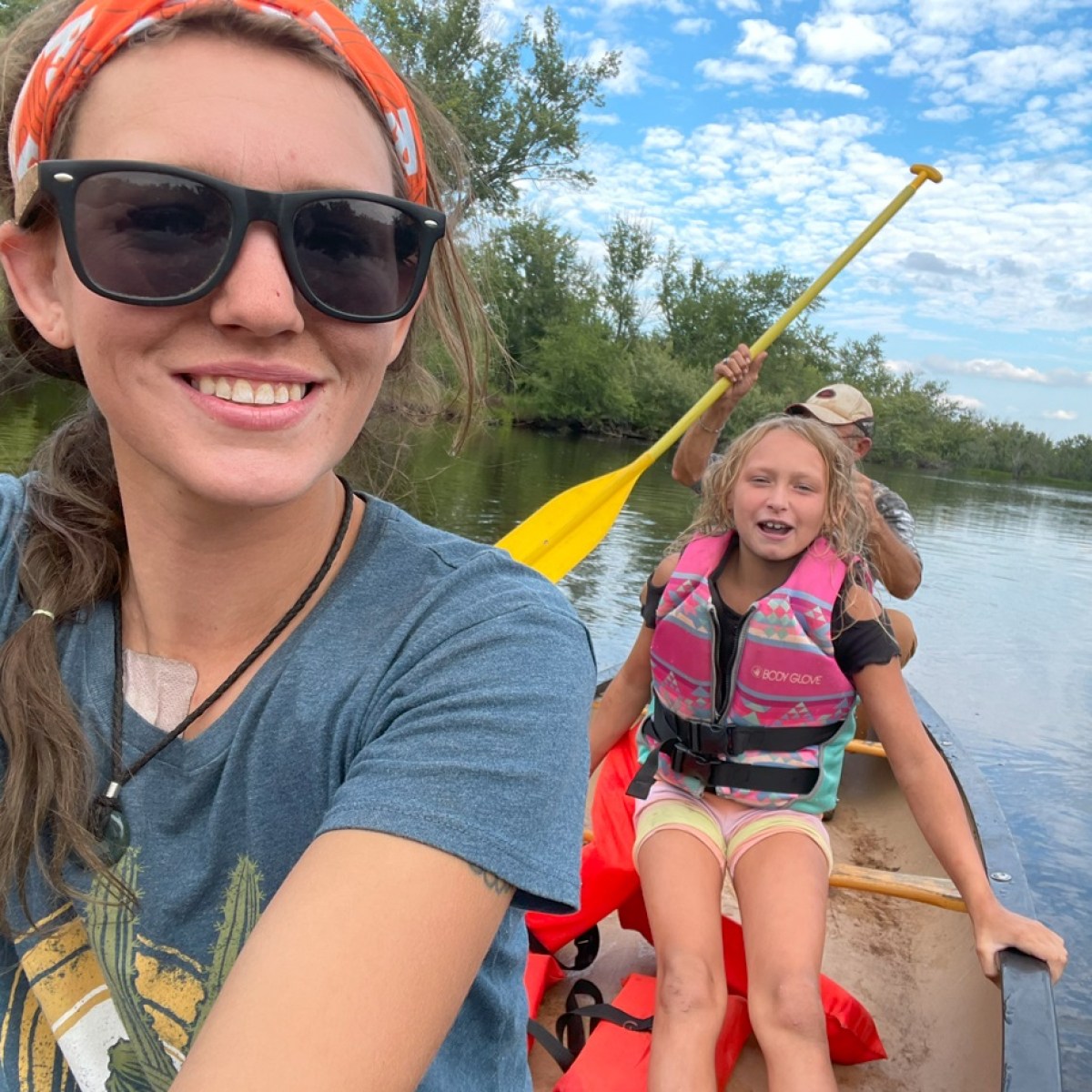 Marie Louise Poulsen wearing sunglasses and smiling next to a body of water