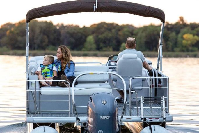 a couple of people riding on the back of a boat