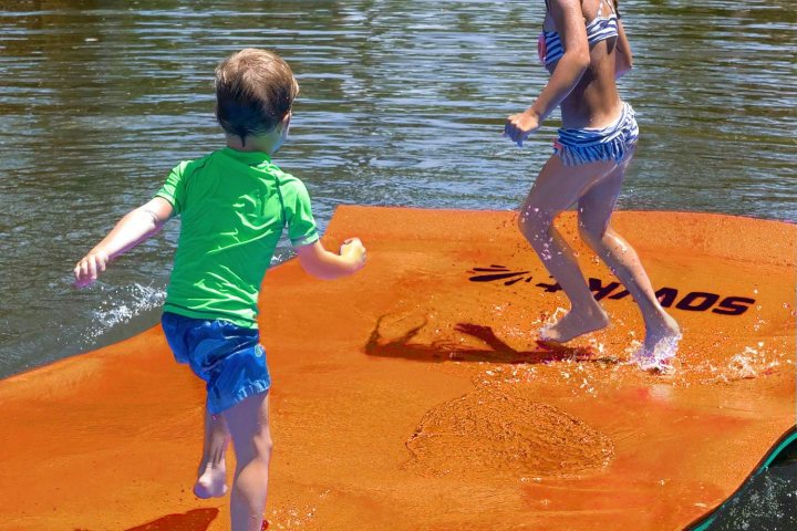 kids playing on a lily pad in the water