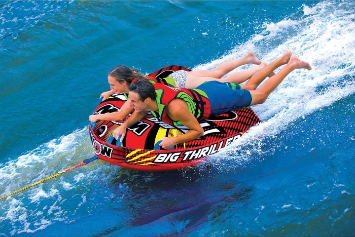 a young girl riding a wave on a surfboard in the water
