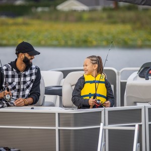 a man and girl fishing from a pontoon