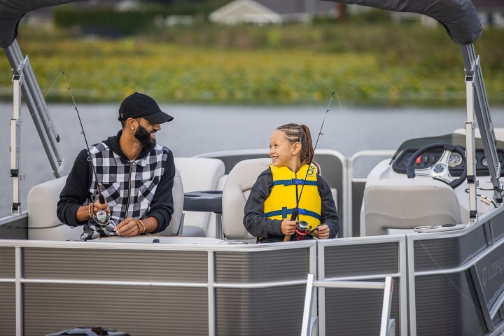 a man and girl fishing from a pontoon