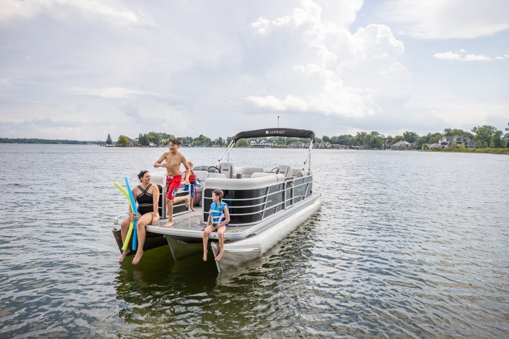 a person riding on the back of a boat in a body of water