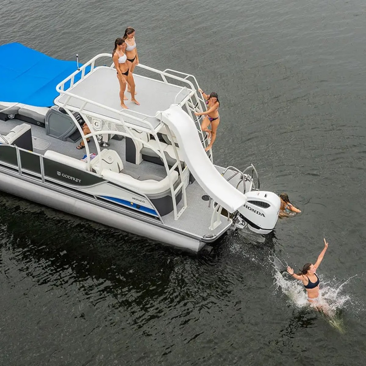 a pontoon with a slide in a lake