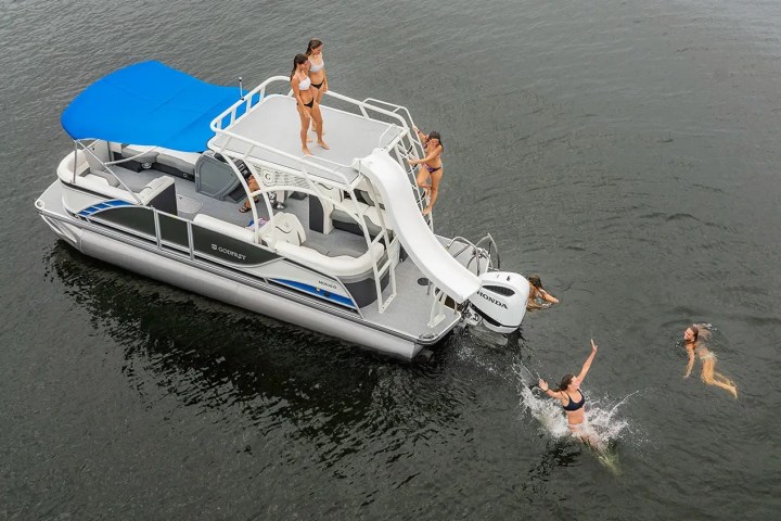 a pontoon with a slide in a lake