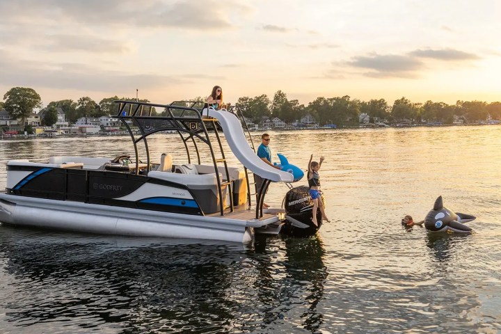 a group of people in a small boat in a body of water