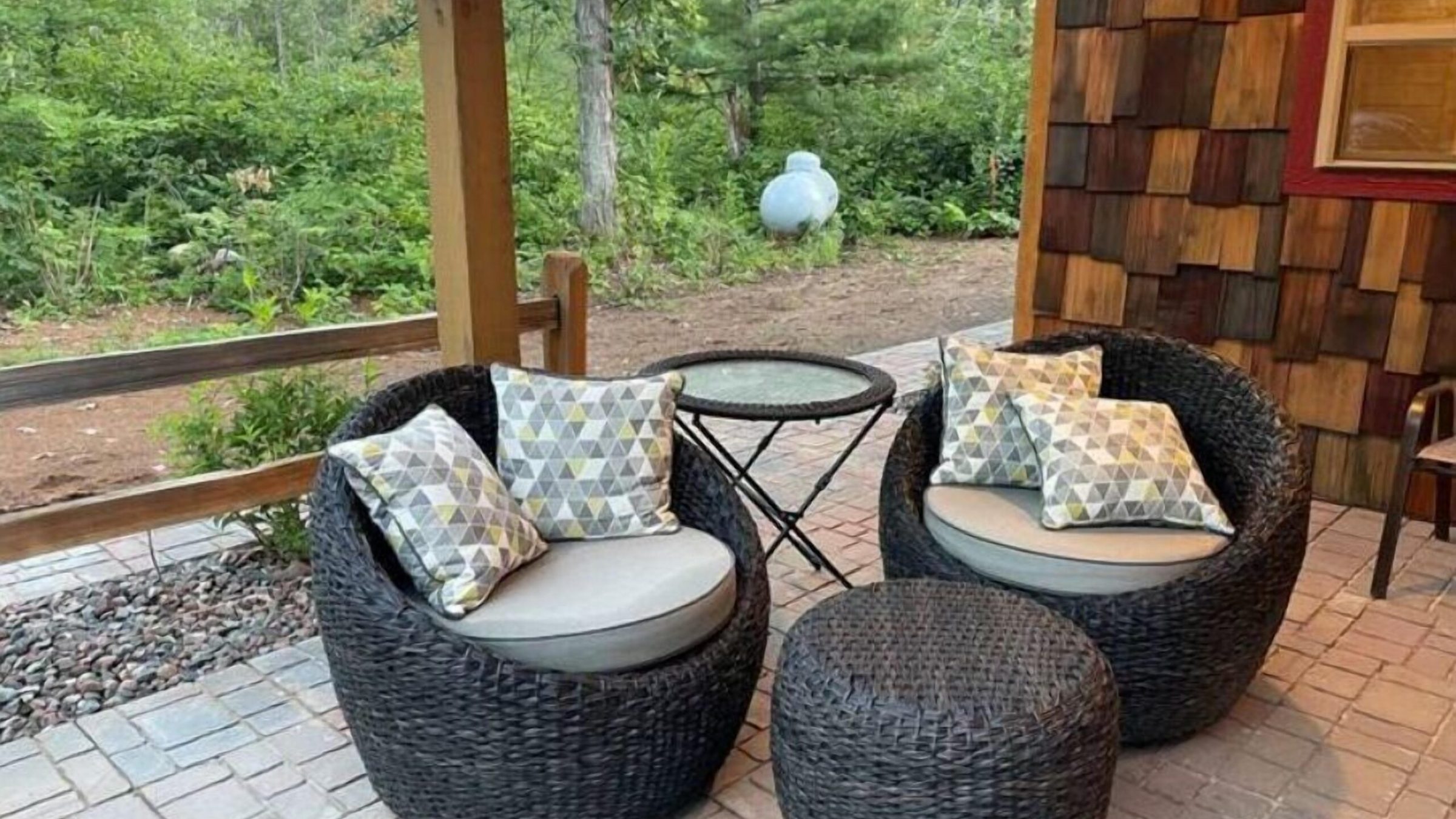 a chair sitting in front of a brick wall