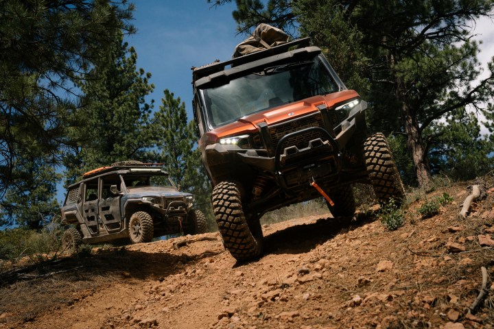 a truck driving down a dirt road