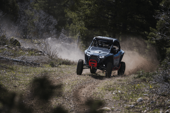 a truck driving down a dirt road