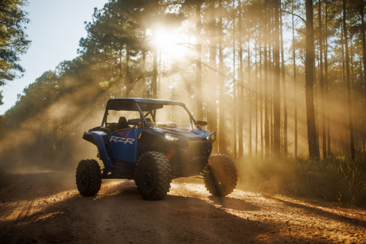 a truck driving down a dirt road