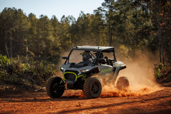 a truck driving down a dirt road