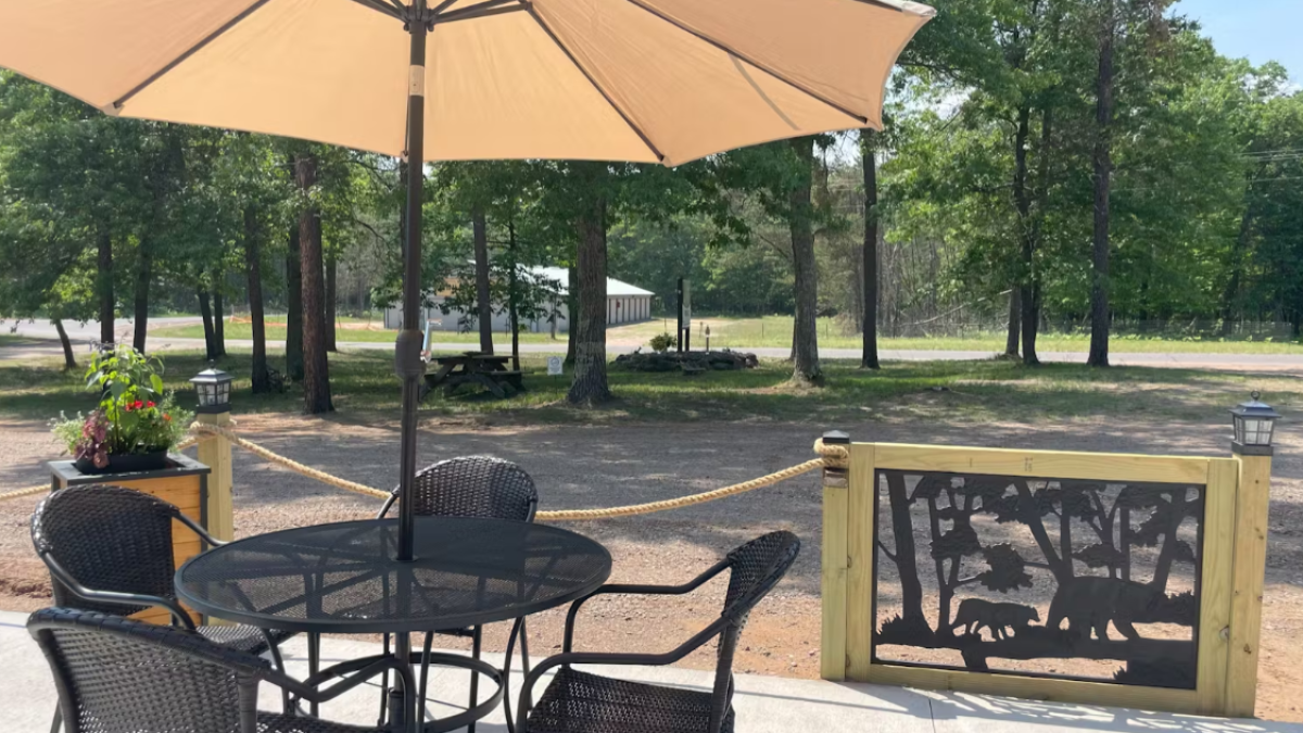 a group of lawn chairs sitting on top of a table umbrella