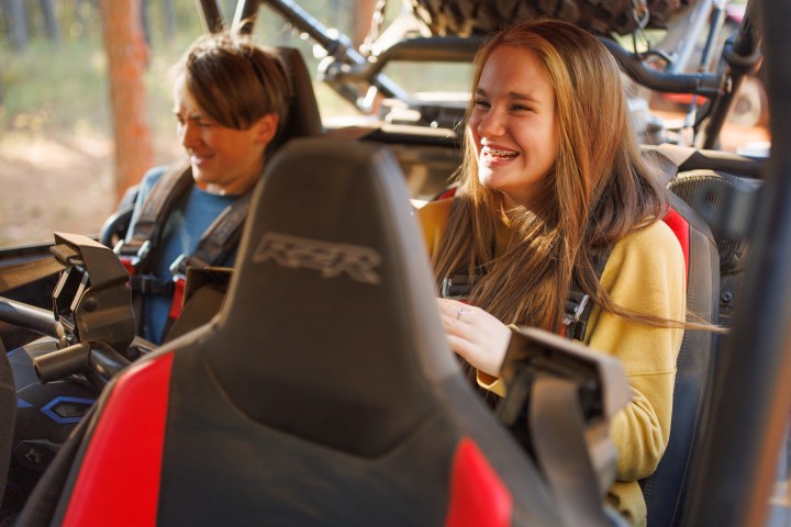 teenagers in the back of a Polaris RZR