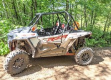 a truck driving down a dirt road
