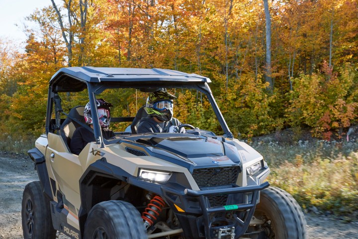 a truck driving down a dirt road