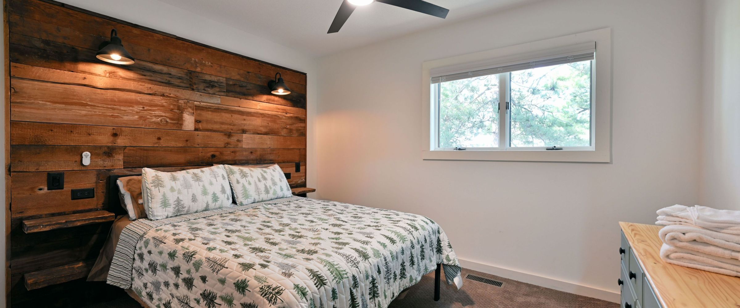 a bedroom with a bed and desk in a room