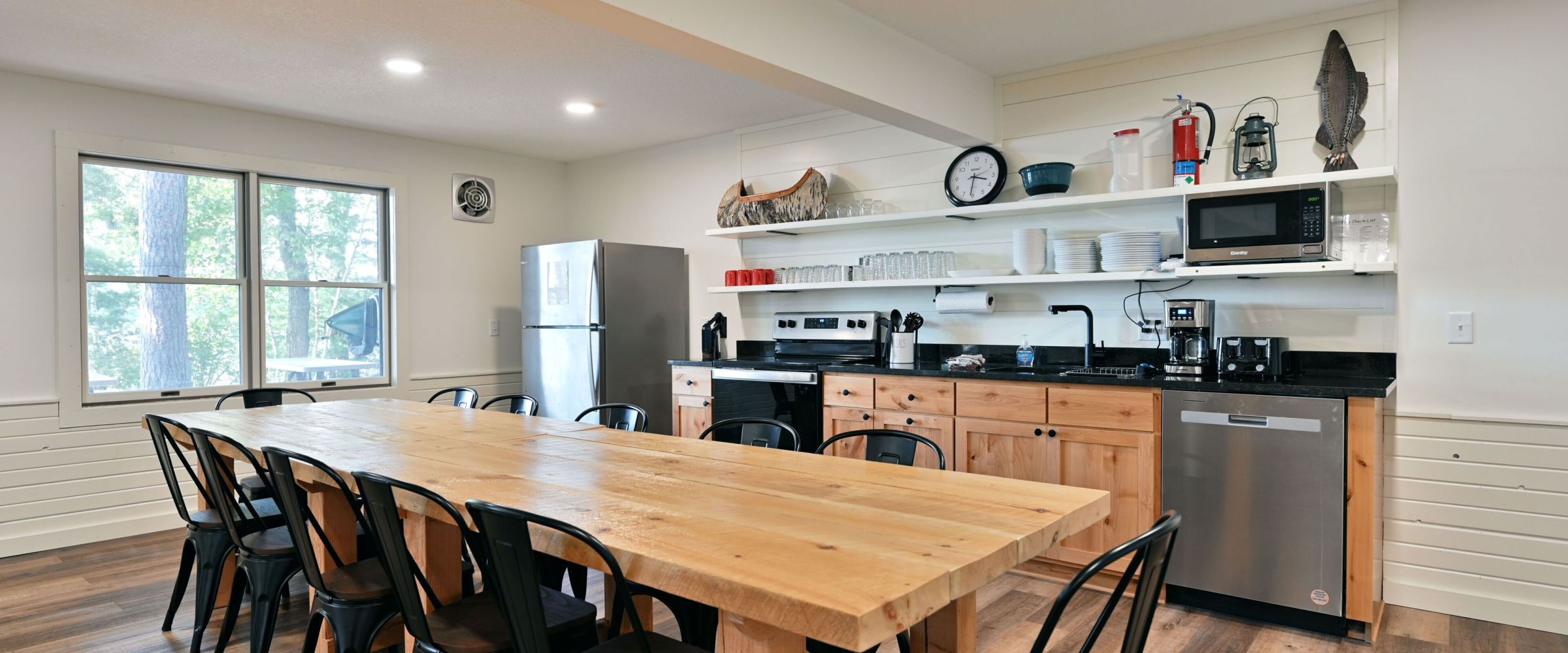 a kitchen with wooden cabinets and a dining room table