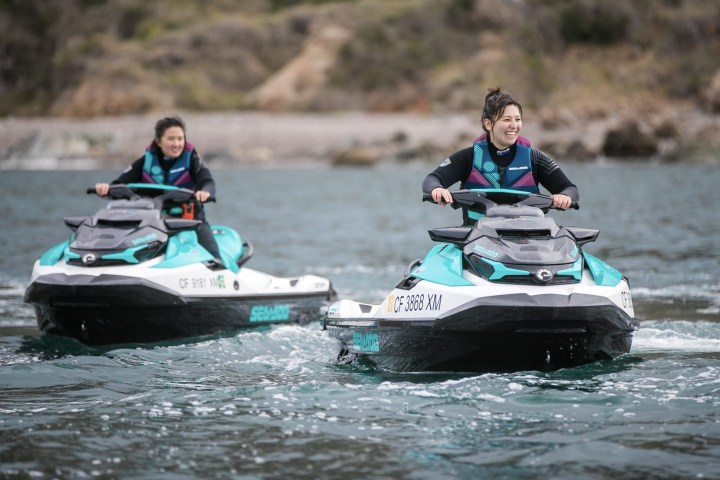 a group of people riding on the back of a boat