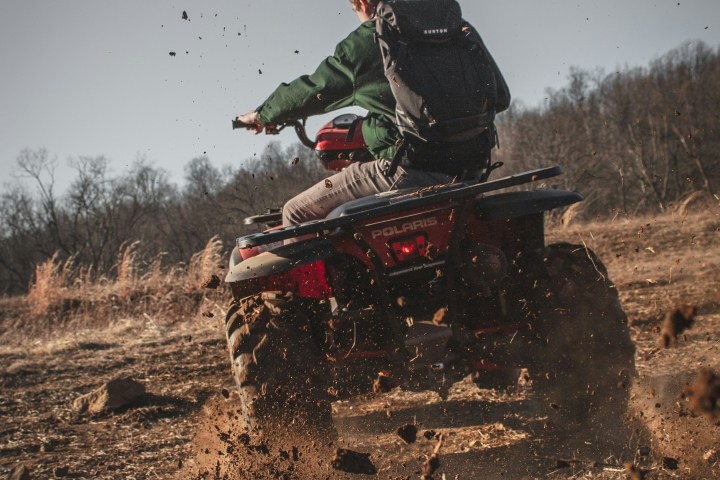 a man flying through the air while riding a bike down a dirt road