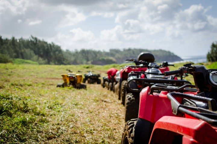 a motorcycle parked on top of a grass covered field