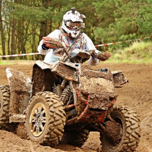 a man riding a bike down a dirt road