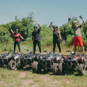 a group of people standing on top of a grass covered field