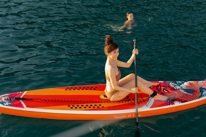 a person riding on the back of a boat on a body of water