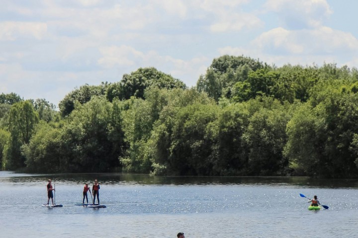 a group of people rowing a boat in the water