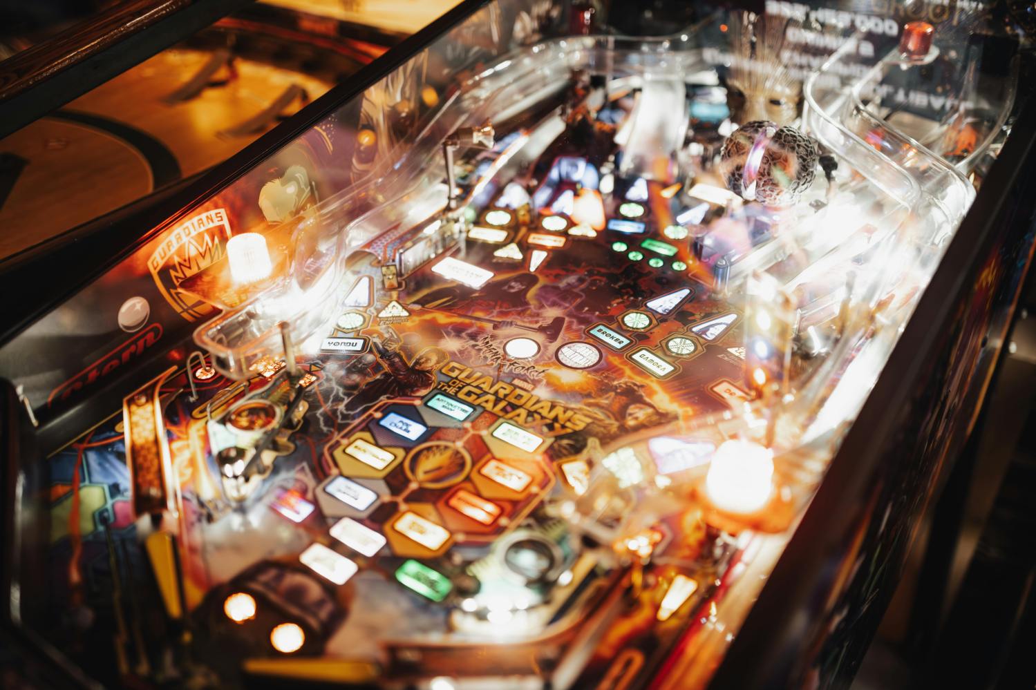 A brightly lit pinball machine with colorful lights and detailed artwork.